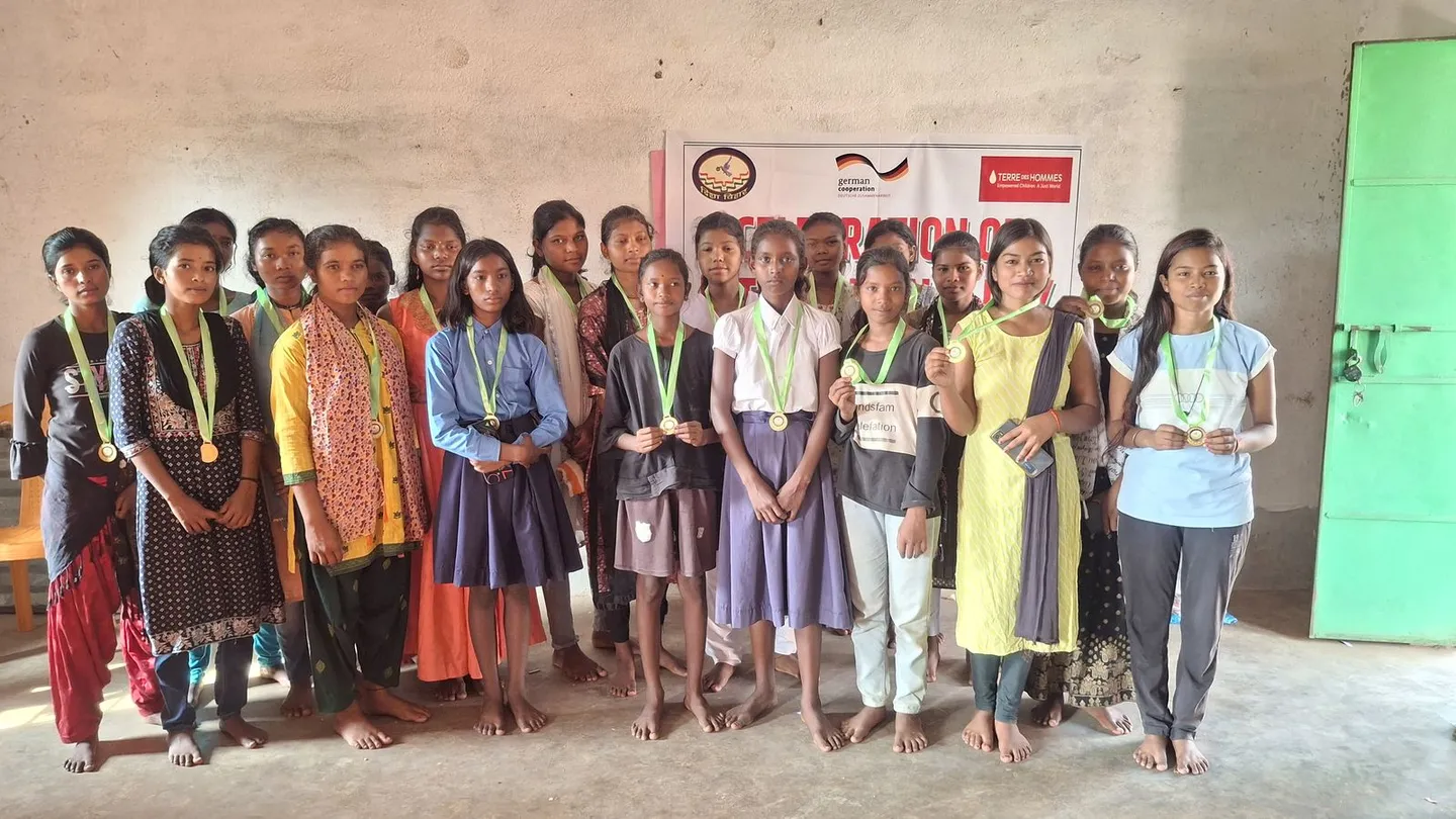 Young women with achievement medals at a Disha Vihar celebration event - slide 1